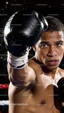 Focused male boxer delivering a powerful punch