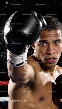 Focused male boxer delivering a powerful punch