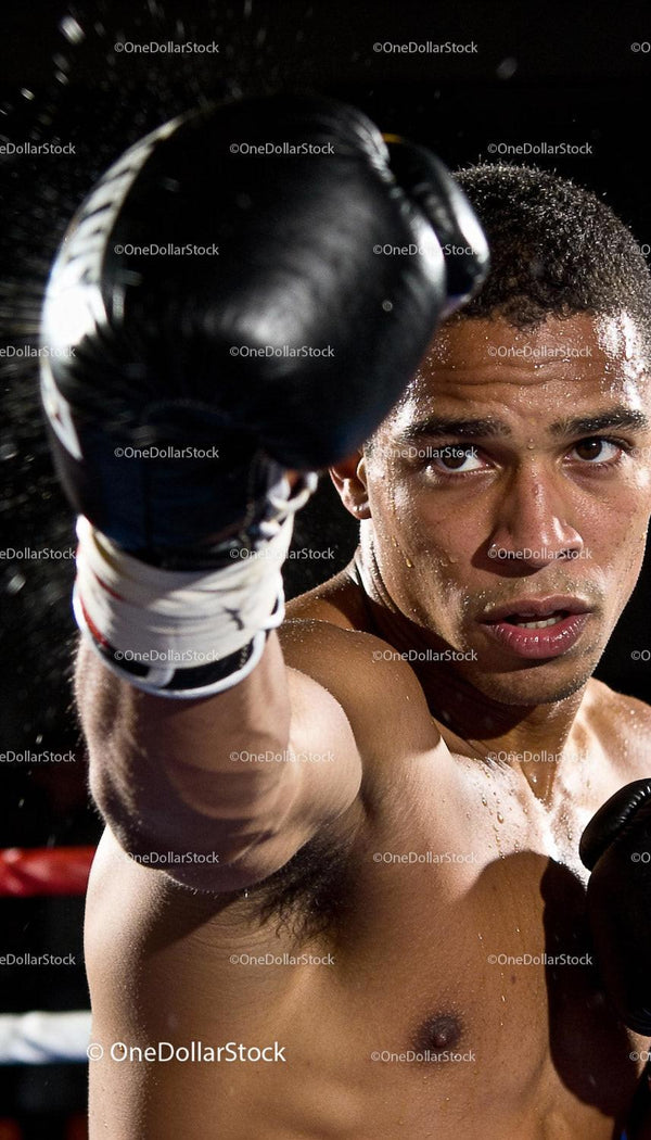 Focused male boxer delivering a powerful punch