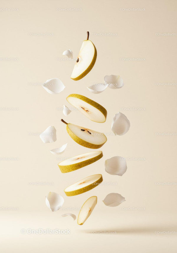 Floating Pear Slices Surrounded by White Flower Petals