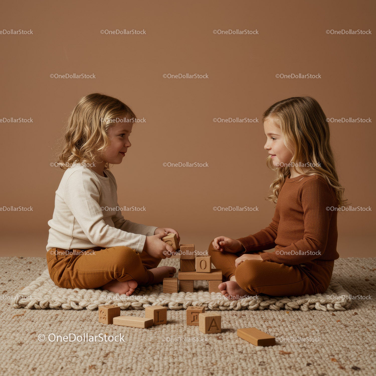 Two young girls playing with wooden blocks indoors