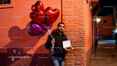 Man Holding Heart Balloons and Chocolates on Romantic Evening