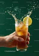 Refreshing iced tea splash with lemon slice in hand
