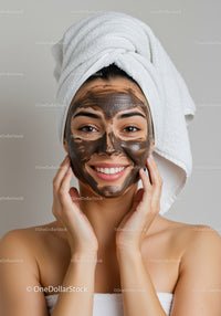 Young Woman Applying Facial Mud Mask for Skincare and Wellness