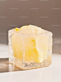 Melting butter cube trapped inside clear ice block