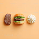 Gourmet Burger with Lettuce and Tomato Next to Grilled Steak and Dumpling