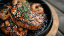 Salmon Steak with Sesame Seeds and Fresh Herbs in a Black Skillet