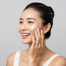 Young Woman Applying Moisturizer for Glowing Skin In Skincare Routine