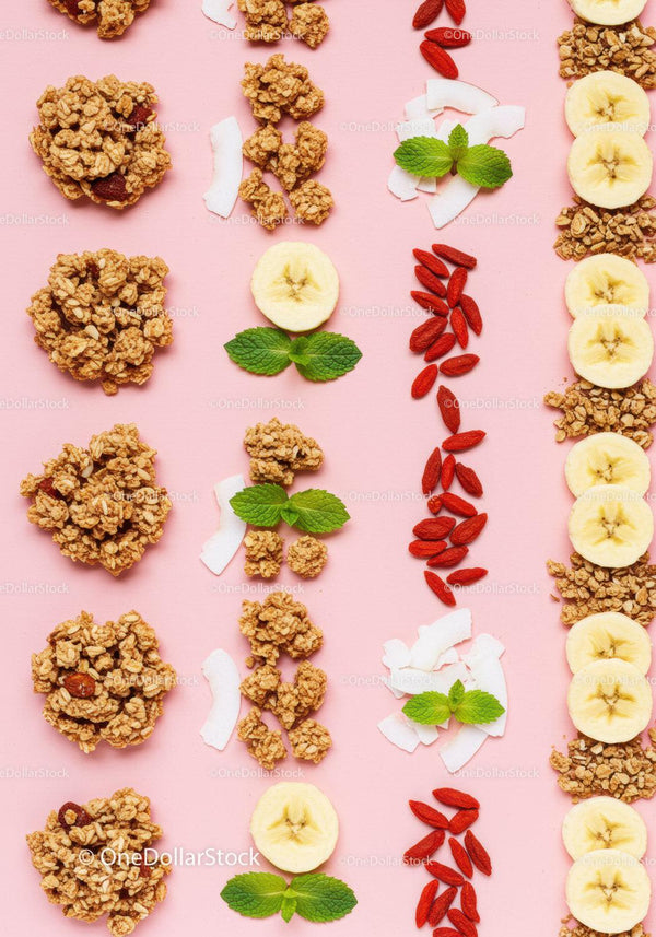 Healthy granola with banana slices and mint on pink