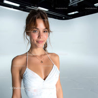 Young Woman Smiling in White Dress in Studio with Minimalist Background