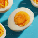 Hard Boiled Eggs with Bright Yellow Yolks on Blue Background