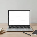 Minimalist laptop workspace with pen and notebooks