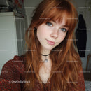 Young Woman with Red Hair and Freckles in Cozy Indoor Setting