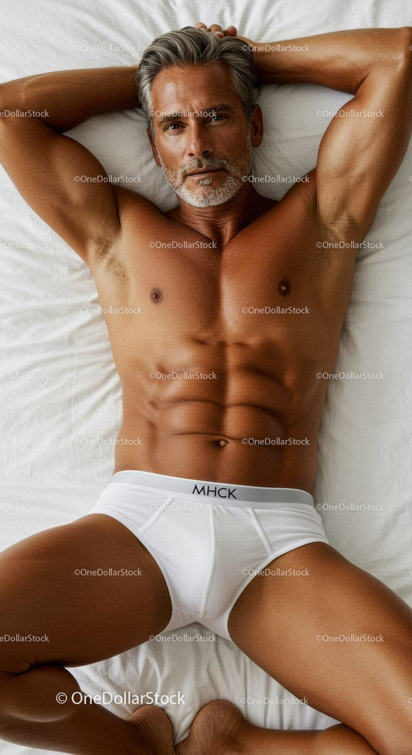 Relaxed mature man lying comfortably on white bed