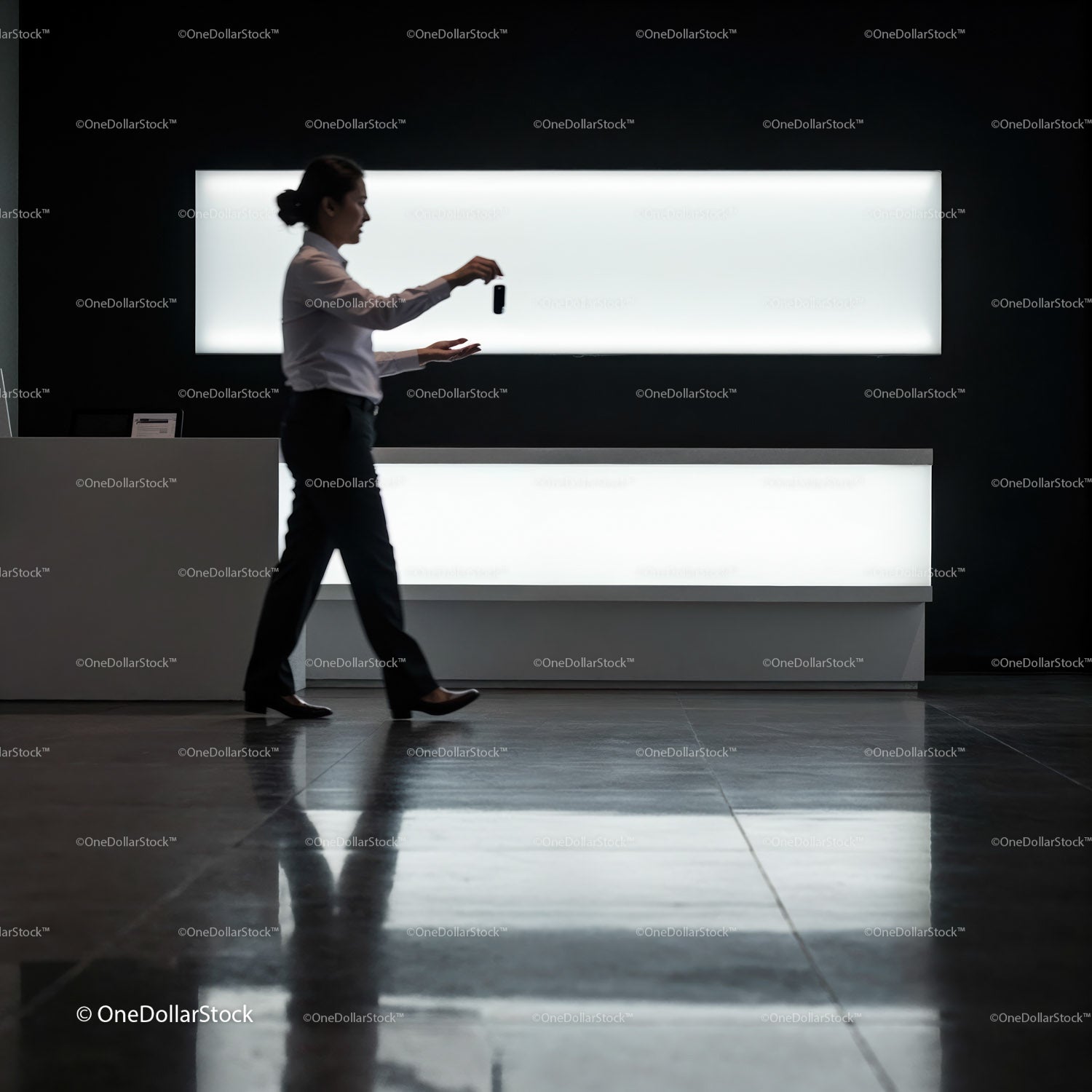 Professional woman walking with keycard in modern lobby