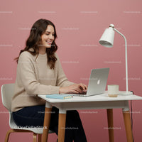 Smiling Woman Using Laptop in Modern Home Office Setup