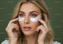 Woman with Blue Eyes Applying Under Eye Patches for Skincare