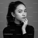Elegant Black and White Portrait of a Young Woman with Hoop Earrings