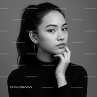 Elegant Black and White Portrait of a Young Woman with Hoop Earrings