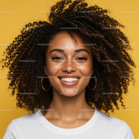 Portrait of a Smiling Woman with Curly Hair Against a Yellow Background