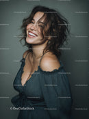 Joyful Woman with Wavy Hair and Bright Smile in Studio Portrait
