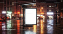 Empty Bus Stop Shelter with Bright Advertisement Light in Night City