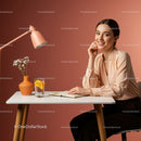 Cheerful Woman Writing at a Table with Flowers and Drinks