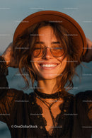 Happy Woman Wearing Hat and Sunglasses Outdoors by the Sea