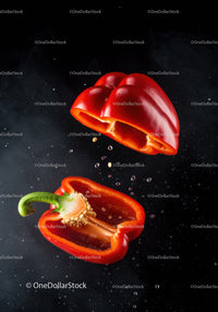 Fresh red bell pepper halves with seeds in motion