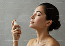 Woman Spraying Water for Skin Refreshment and Hydration