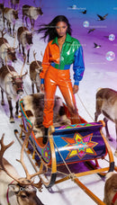 Fashion model posing with colorful sleigh and reindeer
