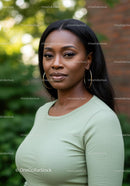 Confident woman posing outdoors with natural background