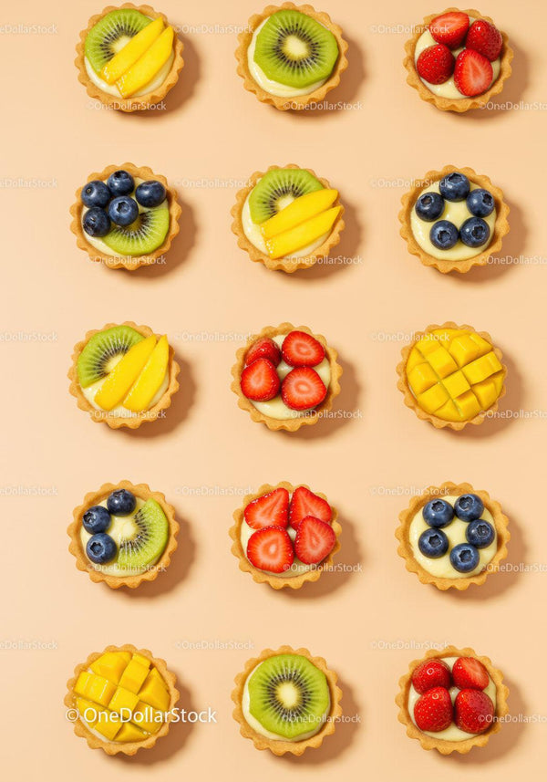 Assorted Mini Fruit Tarts Arranged on Light Background