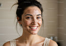 Young Woman with Acne Smiling in Natural Light