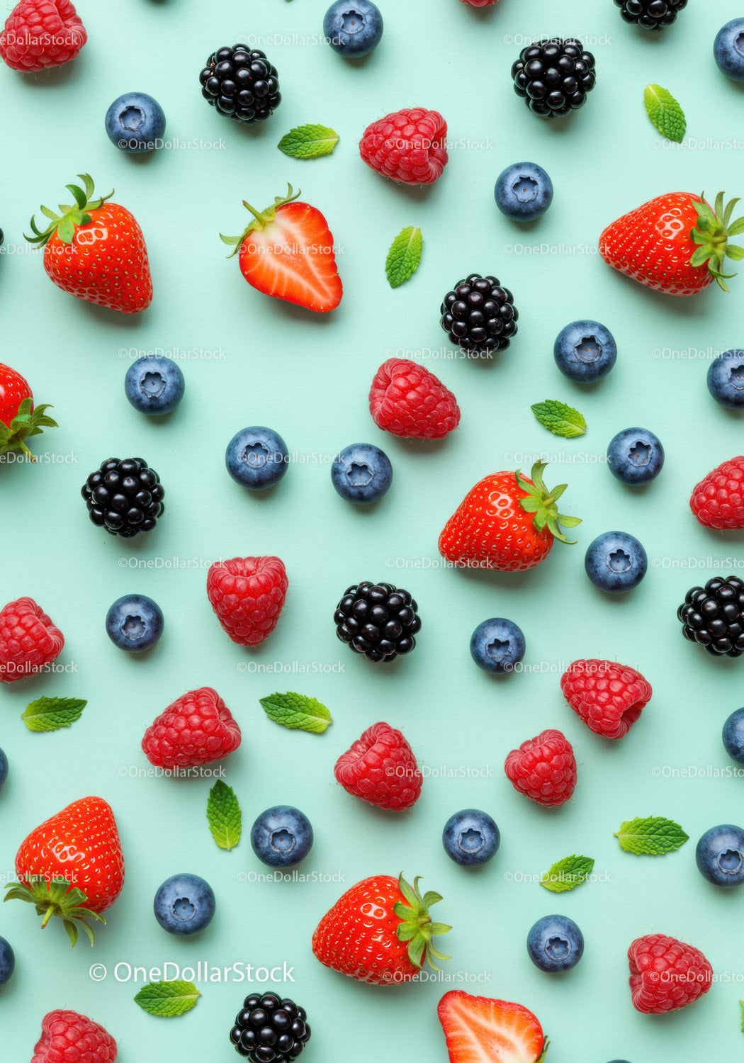 Fresh Mixed Berries and Mint Leaves on Blue Surface