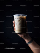 Iced Coffee in Glass Cup with Milk Swirl on Dark Background