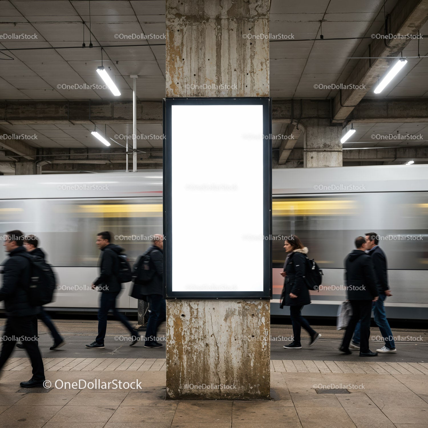 Busy commuters walking past blank illuminated billboard