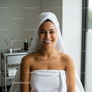 Happy Woman with Fresh Skin at Spa Relaxing in Towel