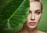 Close-Up of a Woman’s Face with Green Leaf and Water Droplets for Natural Beauty