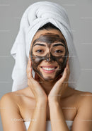 Woman with Facial Mask and Towel Wrapped Hair Ready for Relaxation