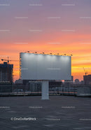City Skyline with Construction Cranes and Sunset Sky
