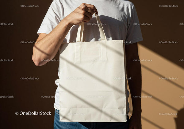 Man Holding Blank Reusable Canvas Tote Bag JPG Mockup Image