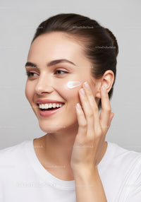 Young Woman Applying Cream in Skincare Routine With Beautiful Skin