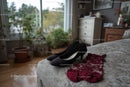 Chic Black Heels and a Red Lace Dress in a Cozy Bedroom Setting