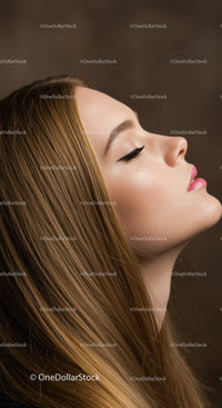 Profile of serene young woman with flawless makeup
