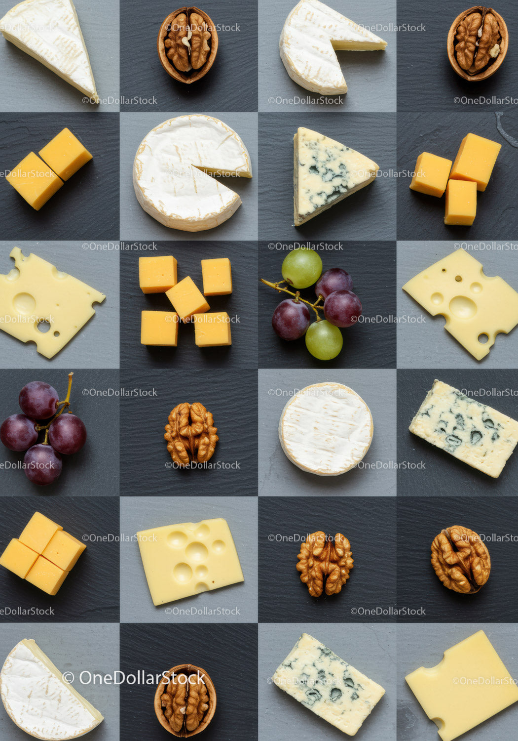 Assorted cheeses walnuts and grapes on dark slate
