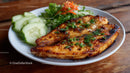 Grilled Fish with Cucumber Slices on Rustic Wooden Table
