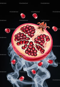 Fresh pomegranate half with seeds and smoky background