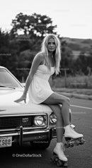 Young Woman in White Dress Sitting on Classic Car with Roller Skates