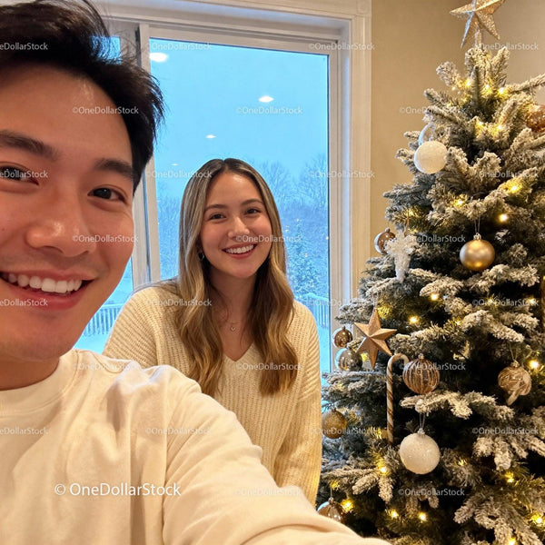 Happy couple celebrating Christmas near decorated tree